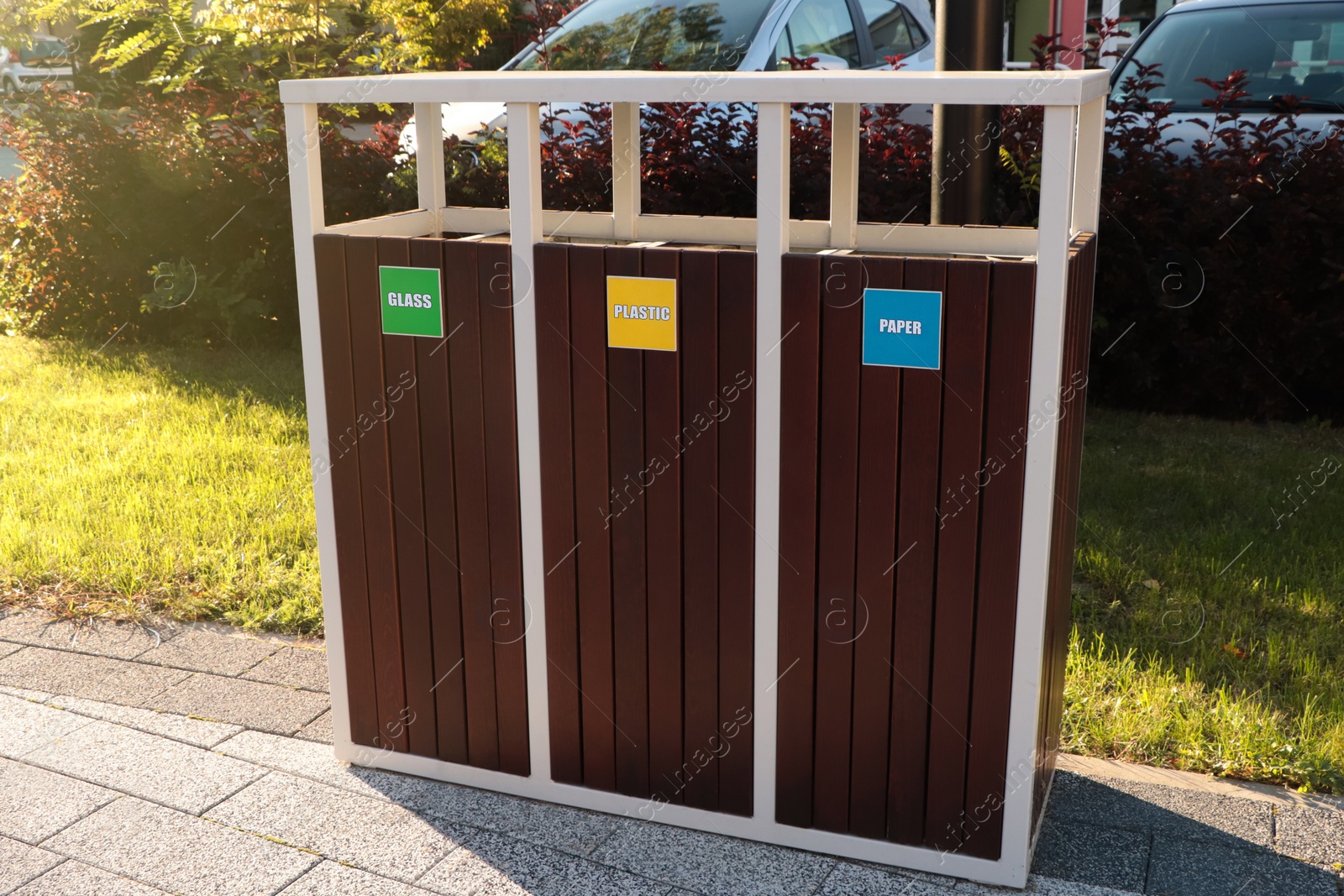 Photo of Different sorting bins for waste recycling on sunny day outdoors