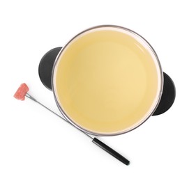 Oil in fondue pot and fork with piece of raw meat isolated on white, top view