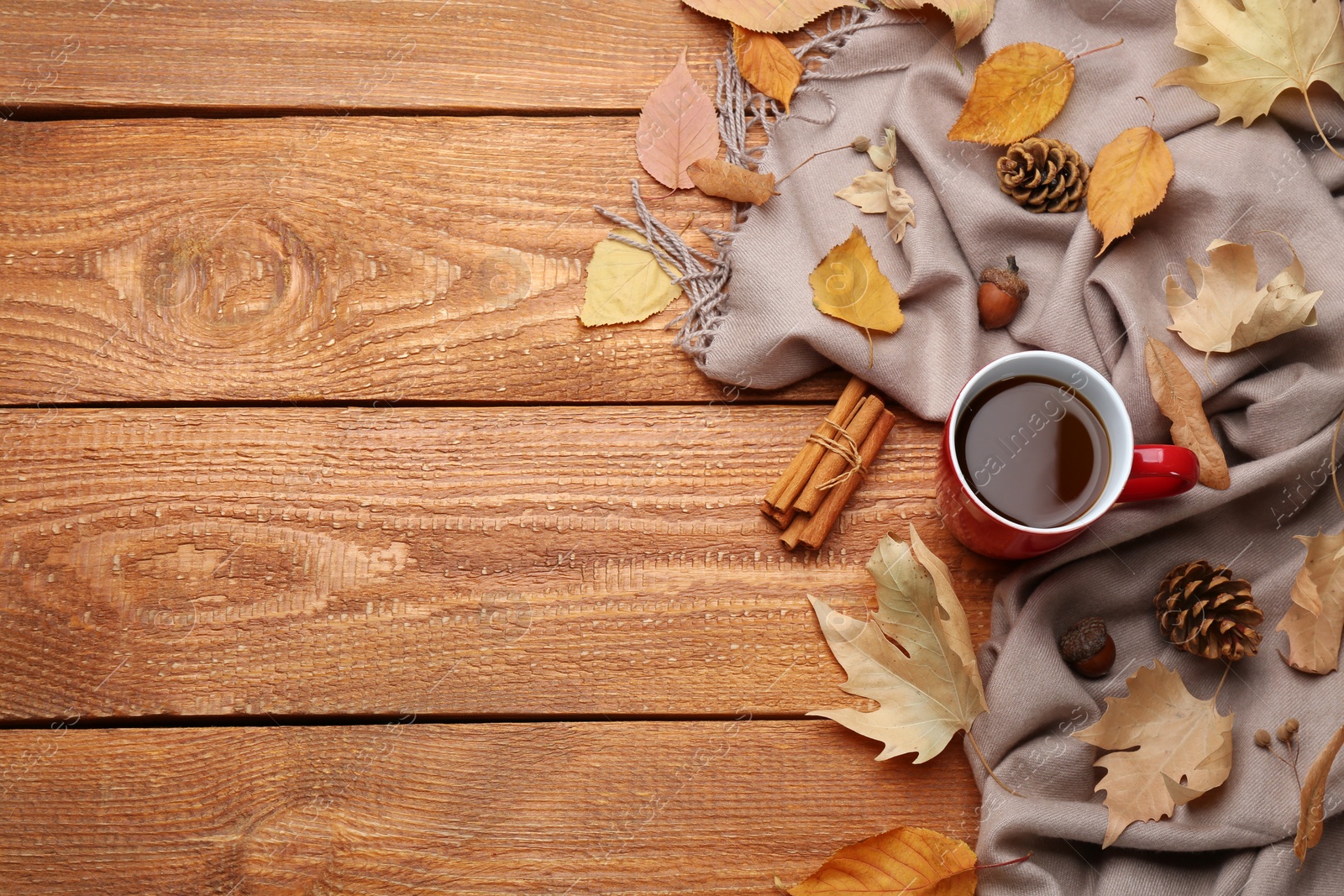 Photo of Flat lay composition with cup of hot drink on wooden table, space for text. Cozy autumn atmosphere