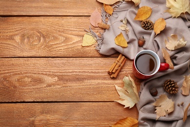 Photo of Flat lay composition with cup of hot drink on wooden table, space for text. Cozy autumn atmosphere