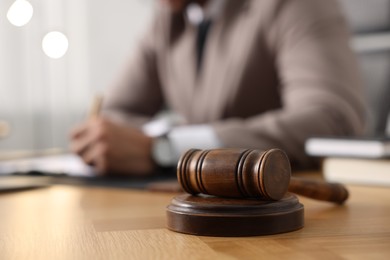 Photo of Lawyer working at table in office, focus on gavel