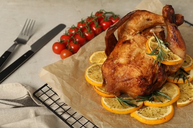 Photo of Chicken with orange slices on light grey table