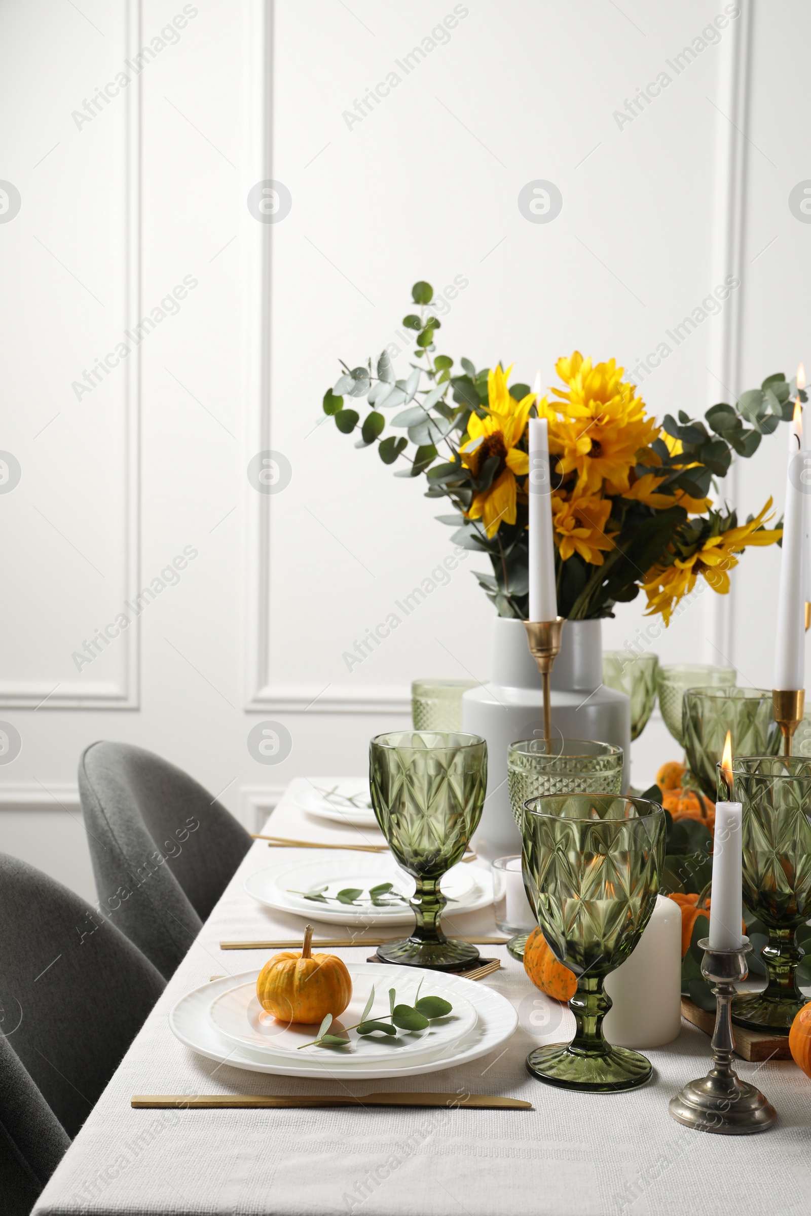 Photo of Beautiful autumn table setting with bouquet indoors. Plates, cutlery, glasses and floral decor