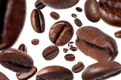 Image of Roasted coffee beans falling o white background