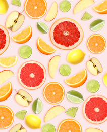 Image of Tropical layout with fresh citrus fruits and apples on pale pink background, top view