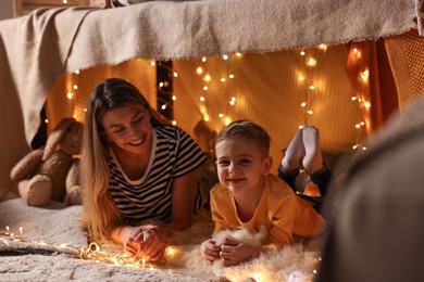 Mother and her son in play tent at home