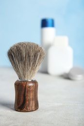 Photo of Shaving brush on table against blurred background