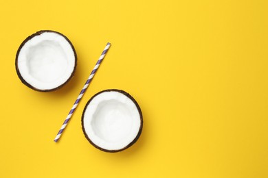 Photo of Percent sign made of coconut halves and straw on yellow background, flat lay. Space for text