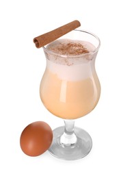 Photo of Delicious eggnog in glass, cinnamon and egg isolated on white