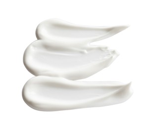 Photo of Samples of facial cream on white background