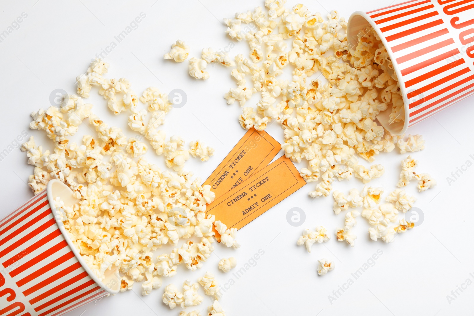 Photo of Popcorn and tickets on white background, top view. Cinema snack