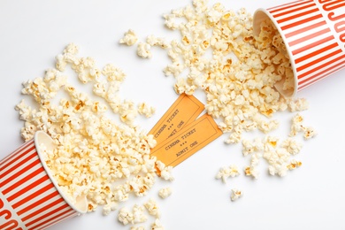 Photo of Popcorn and tickets on white background, top view. Cinema snack