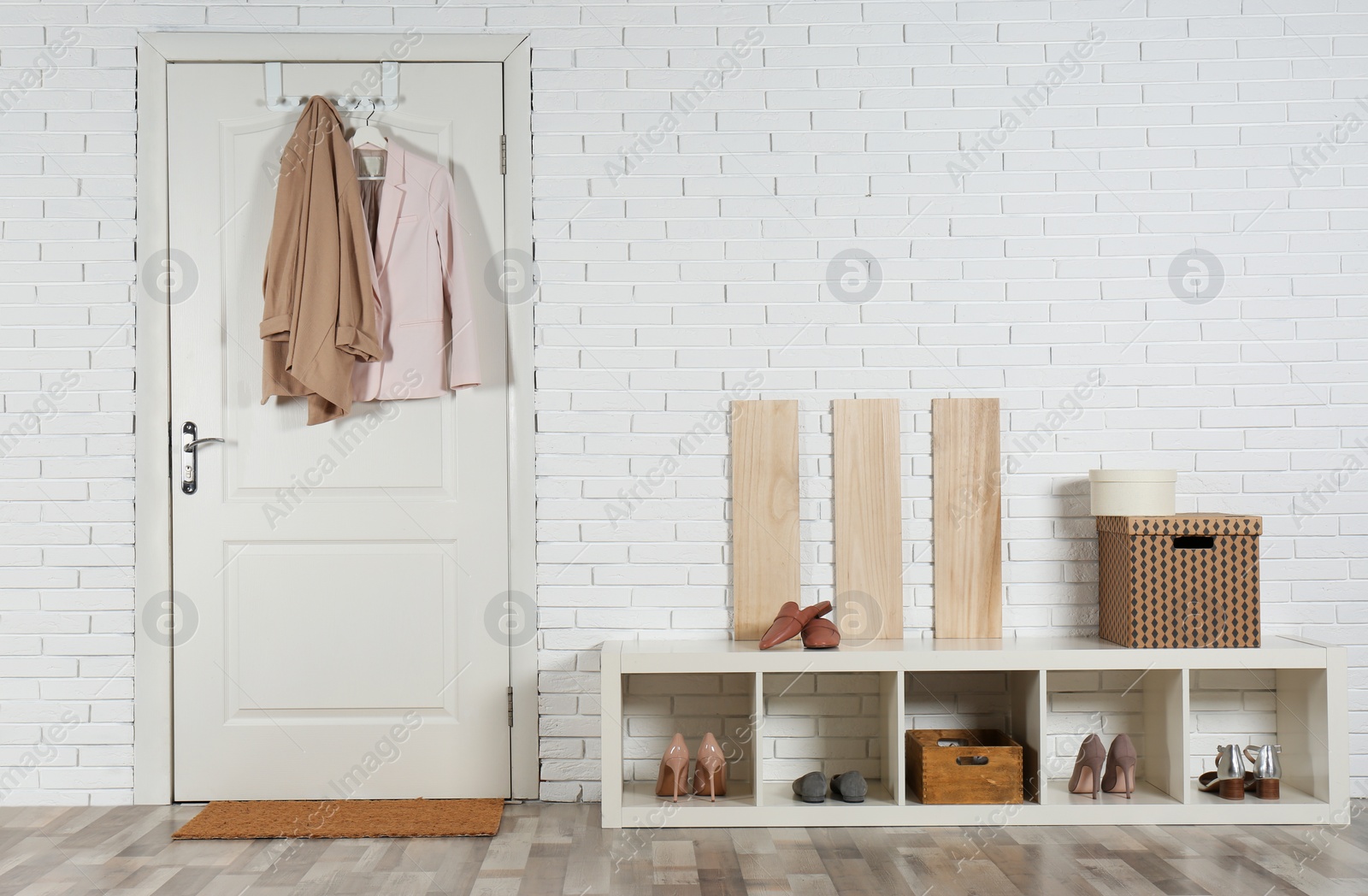 Photo of Hallway interior with shoe rack and mat near door