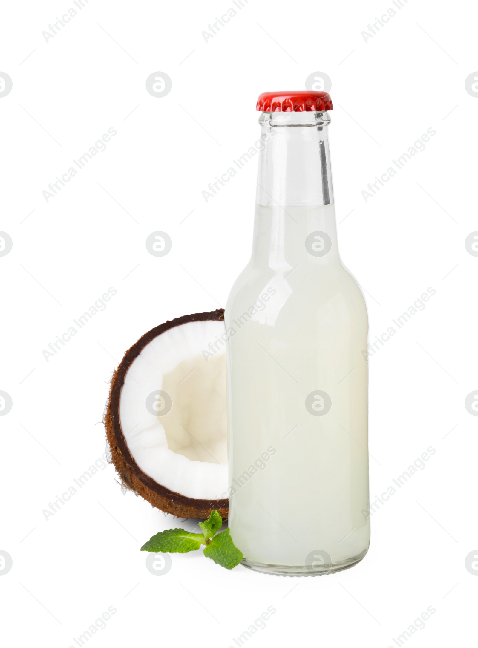 Photo of Delicious kombucha in glass bottle, coconut and mint isolated on white