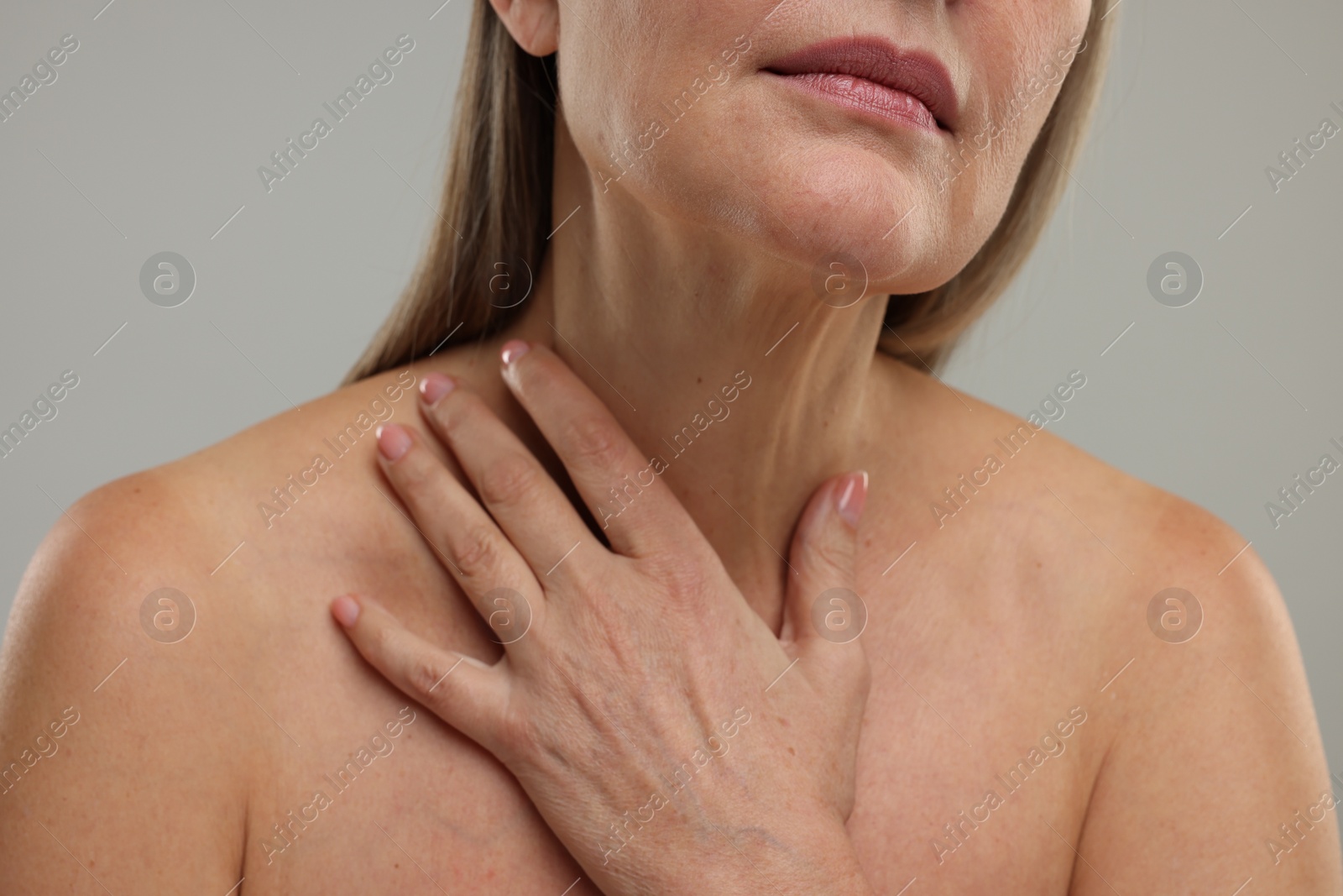 Photo of Mature woman with healthy skin on grey background, closeup