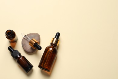 Photo of Flat lay composition with face serums on beige background. Space for text