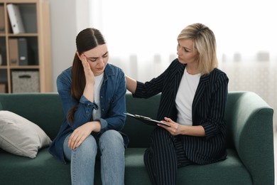 Photo of Psychotherapist working with patient on sofa in office