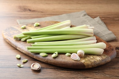 Board with fresh lemongrass stalks on wooden table