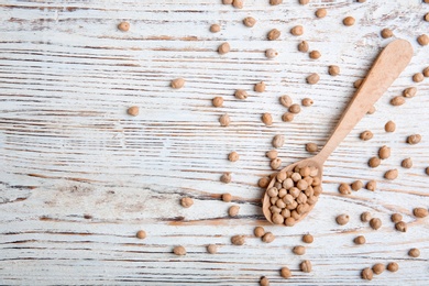 Flat lay composition with dried peas on wooden background