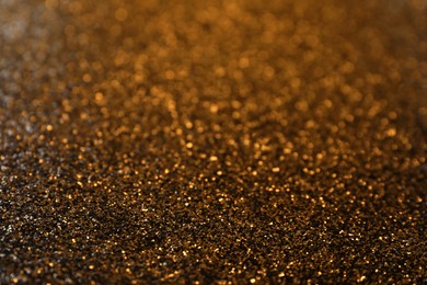 Photo of Shiny bronze glitter as background. Bokeh effect