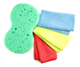 Photo of Sponge and car wash cloths on white background, top view