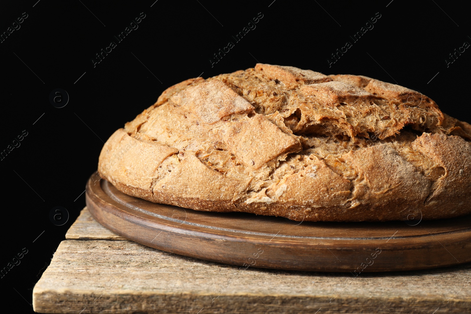 Photo of Freshly baked sourdough bread on wooden table