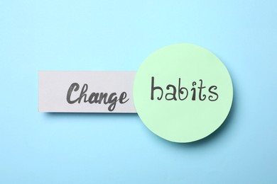 Photo of Flat lay composition with phrase Change Habits on light blue background