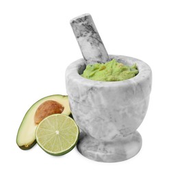 Photo of Mortar with delicious guacamole, avocado and lime isolated on white