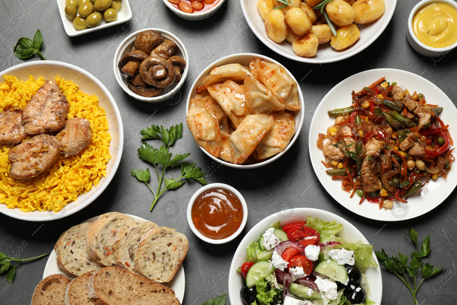 Photo of Buffet service. Many different dishes on grey table, flat lay