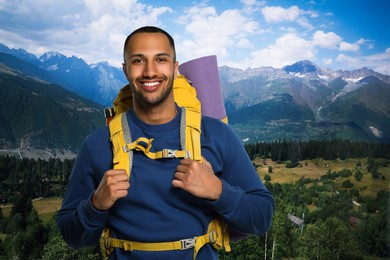 Happy tourist with yellow backpack in mountains