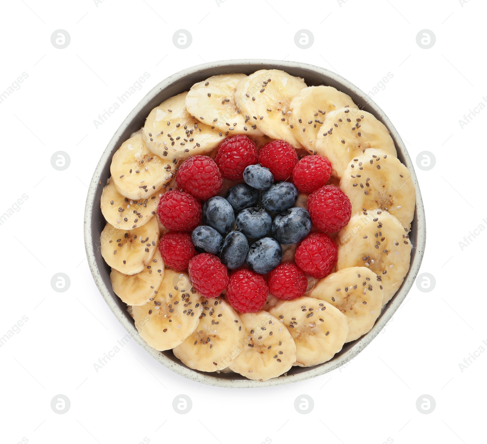 Photo of Tasty breakfast with berries, banana and chia seeds in bowl on white background, top view