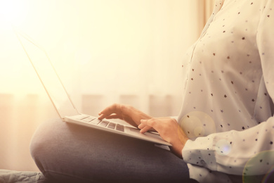 Image of Woman working with laptop at home, closeup