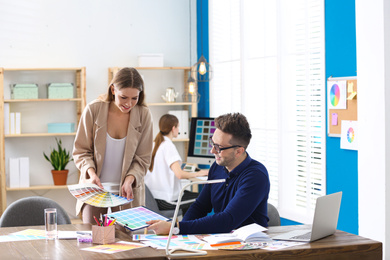 Photo of Professional interior designer with colleague working in office