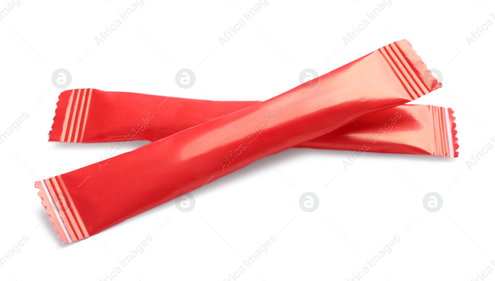 Photo of Red sticks of sugar on white background