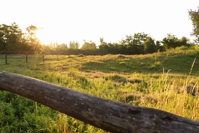 Photo of Picturesque view of countryside with wooden fence in morning