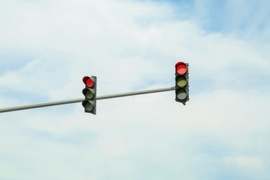 Photo of Overhead traffic lights in city. Road rules