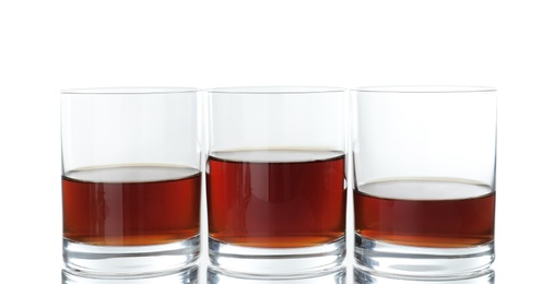 Glasses of scotch whiskey on white background