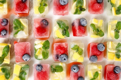 Photo of Flat lay composition with fruit and berry ice cubes on table