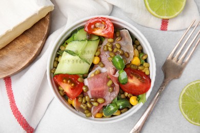 Photo of Bowl of salad with mung beans on white table, flat lay