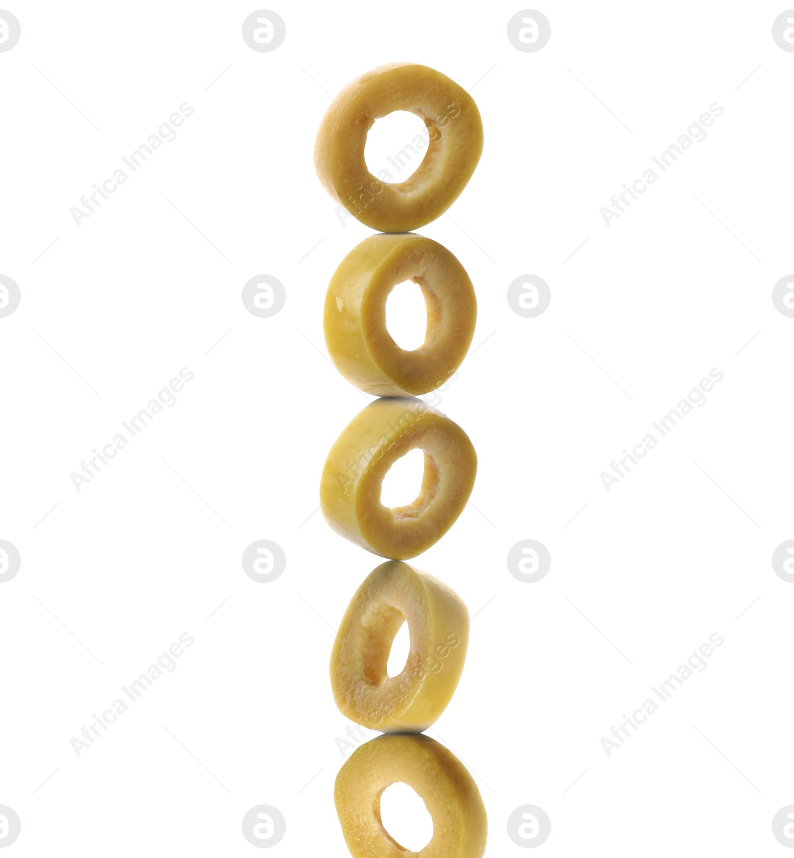 Image of Stacked slices of green olive on white background