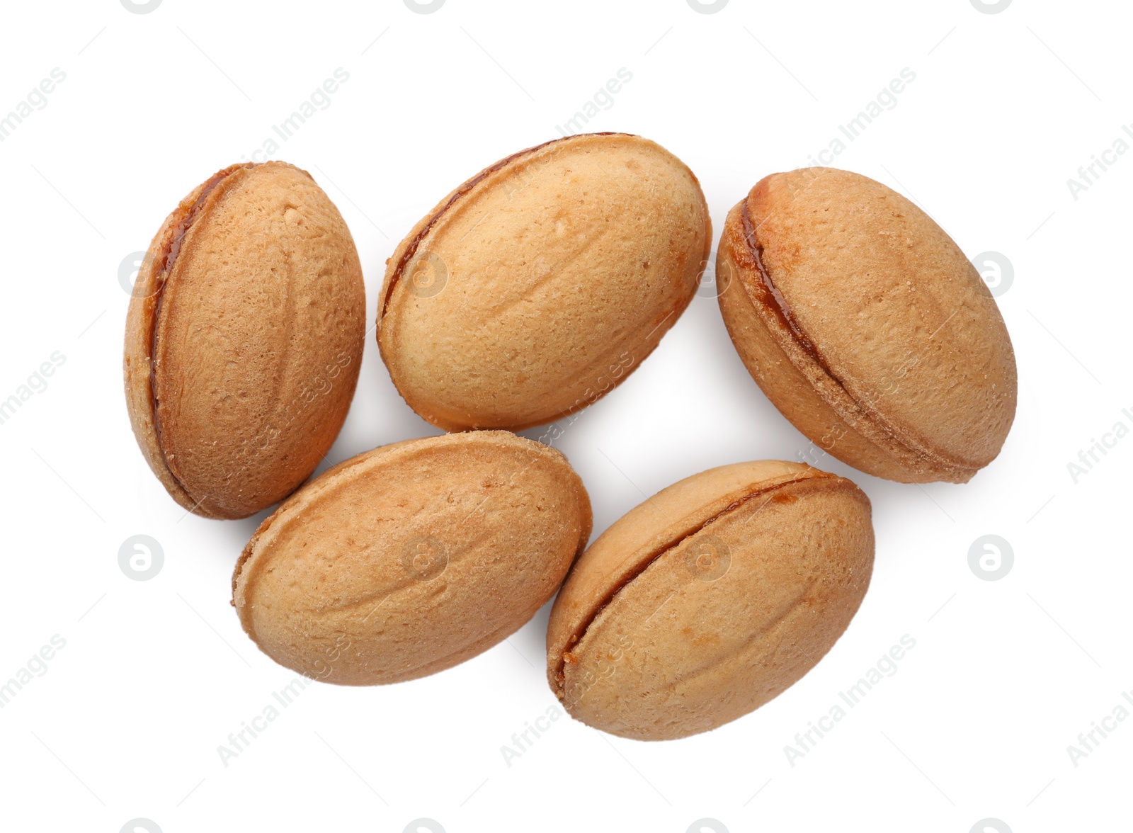 Photo of Delicious nut shaped cookie with boiled condensed milk on white background, top view