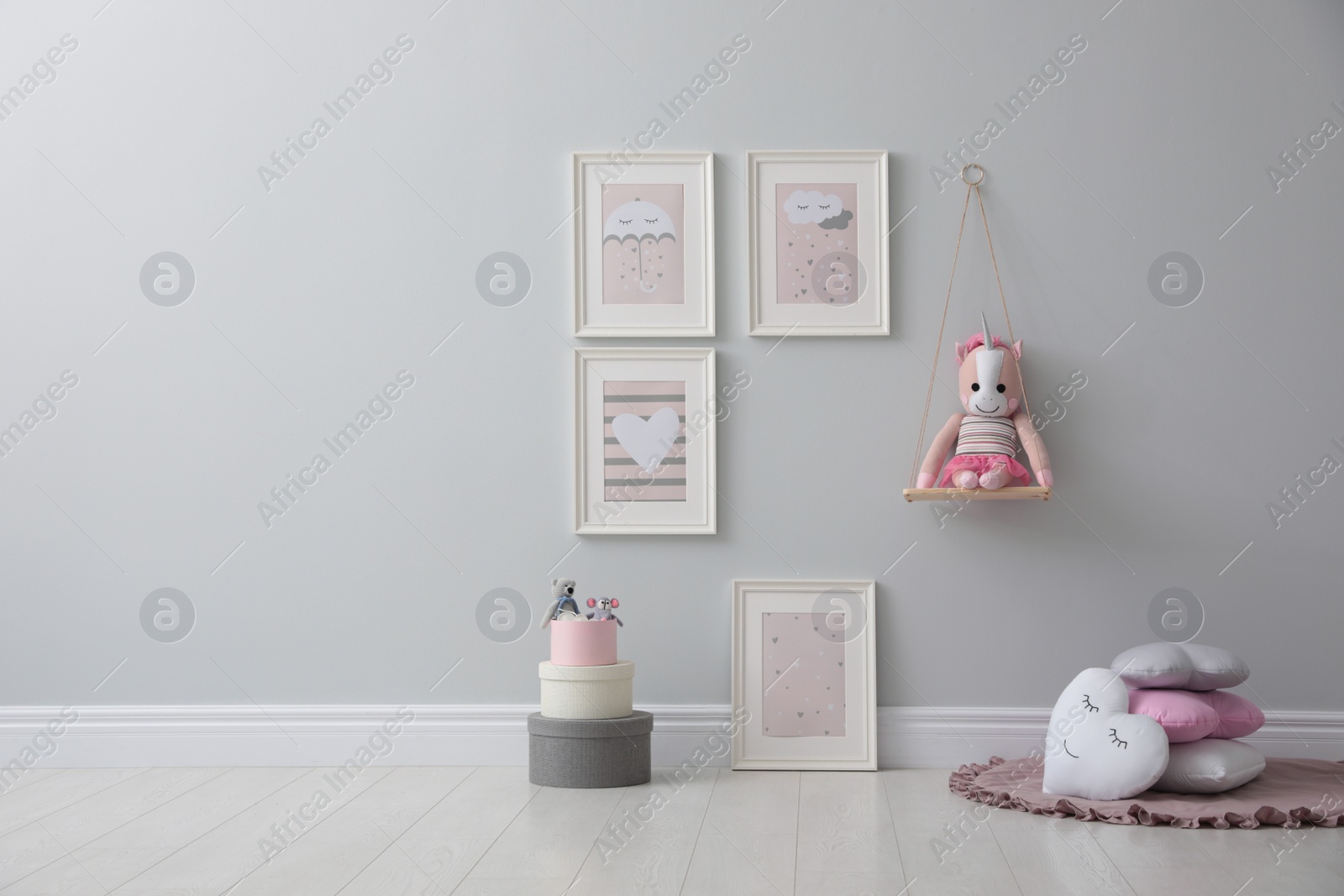 Photo of Stylish room interior with beautiful pictures and toys