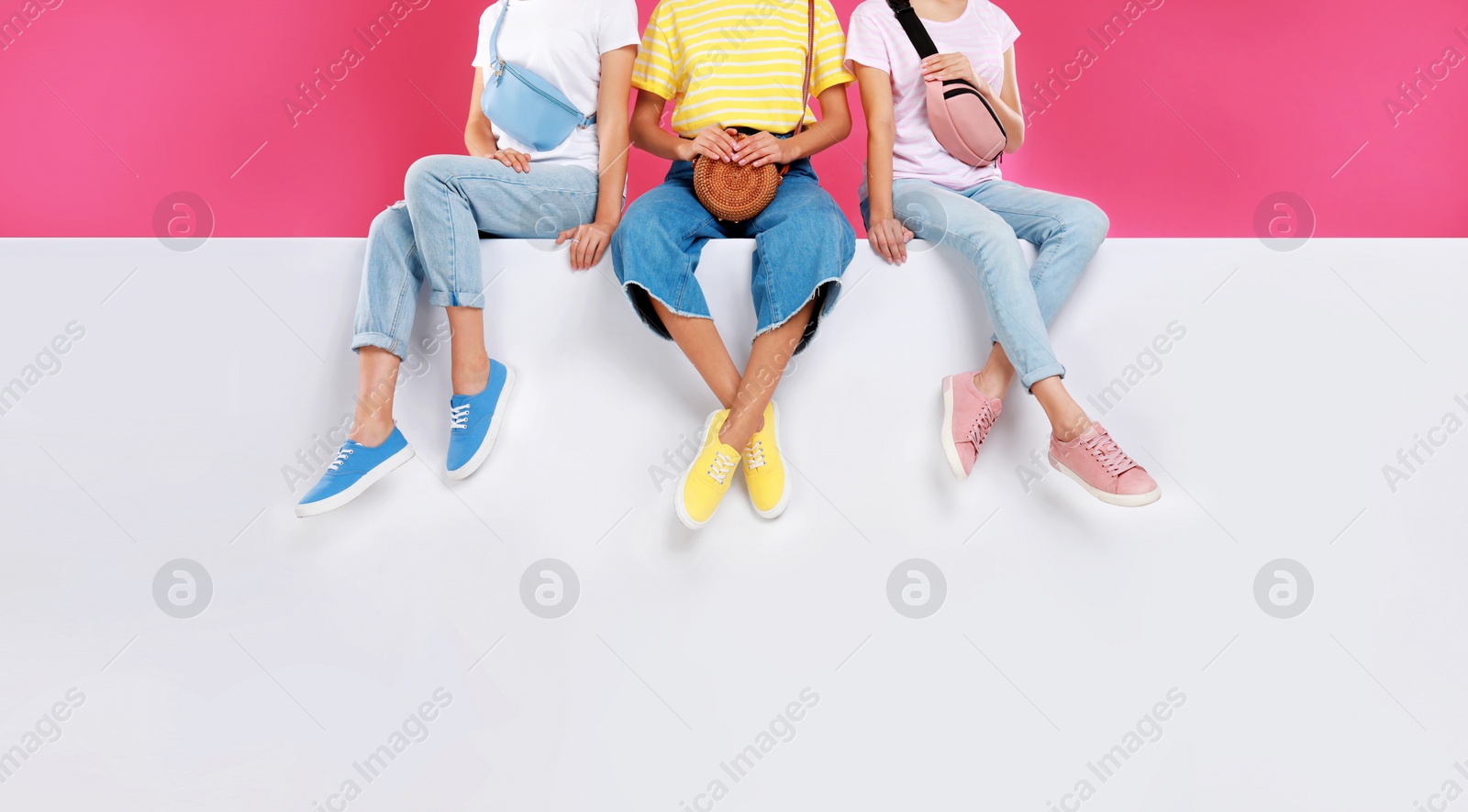 Photo of Women wearing stylish shoes on color background, closeup