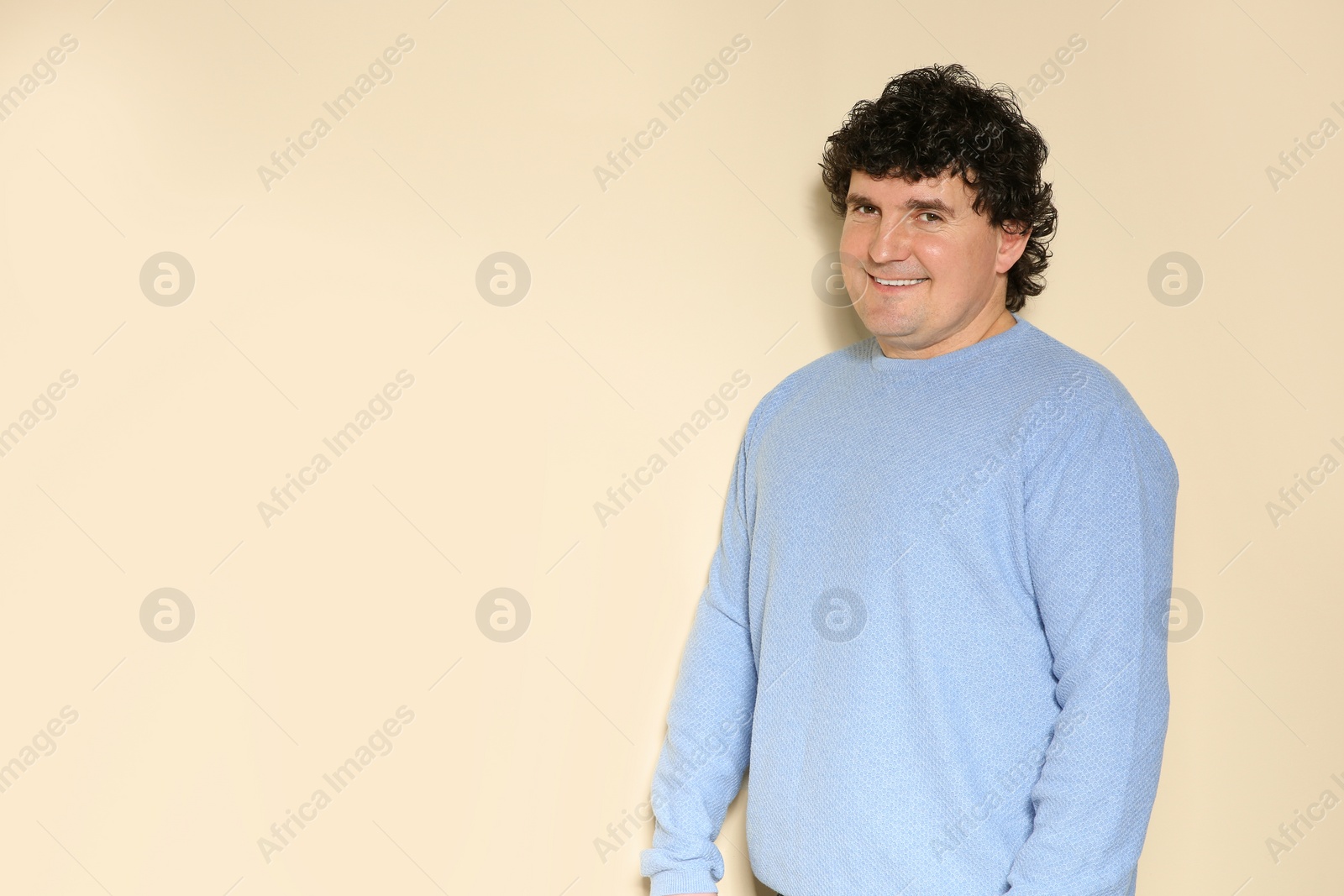 Photo of Portrait of handsome mature man posing on color background. Space for text