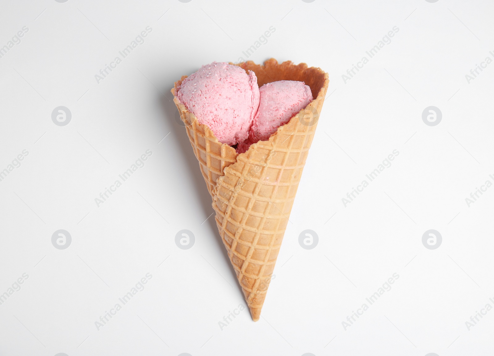 Photo of Delicious ice cream in wafer cone on white background, top view