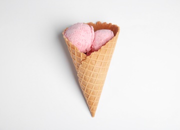 Photo of Delicious ice cream in wafer cone on white background, top view