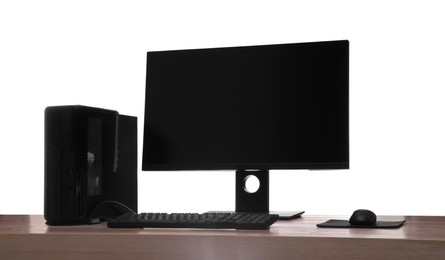 Photo of Modern computer with blank monitor screen and peripherals on wooden table against white background