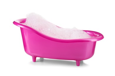 Photo of Pink toy bathtub with foam isolated on white