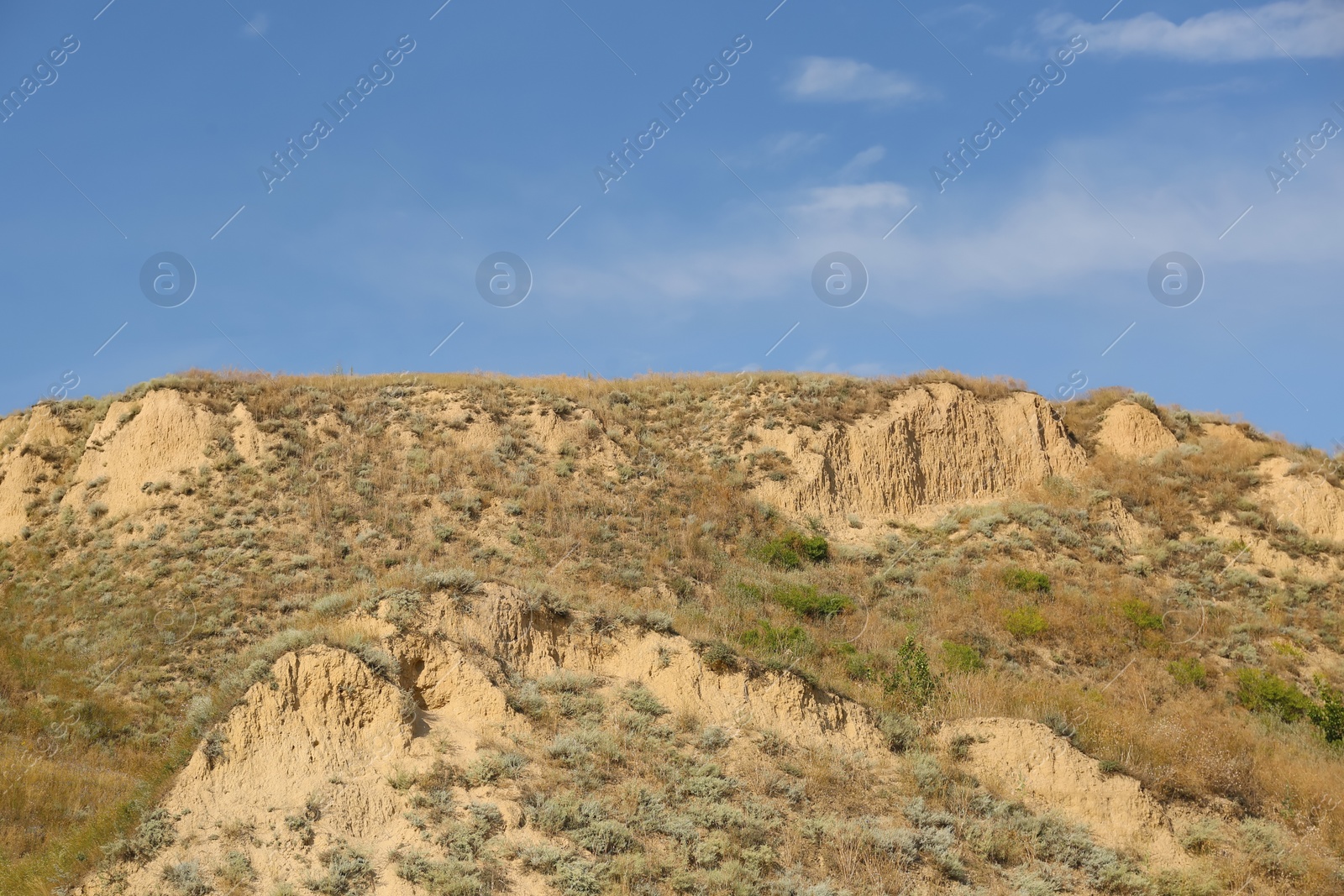 Photo of Beautiful view of sandy hill under blue sky