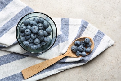 Flat lay composition with juicy blueberries on color table